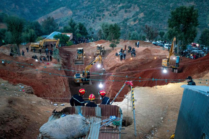 TOPSHOT - Moroccan authorities and firefighters work to rescue five-year-old boy Rayan, who is trapped in a deep well for over two days, near Bab Berred in Morocco's rural northern province of Chefchaouen on February 3, 2022. - Moroccans waited anxiously as authorities said a dramatic operation to rescue a young boy trapped in a deep well for more than 40 hours was nearing its end. (Photo by AFP)